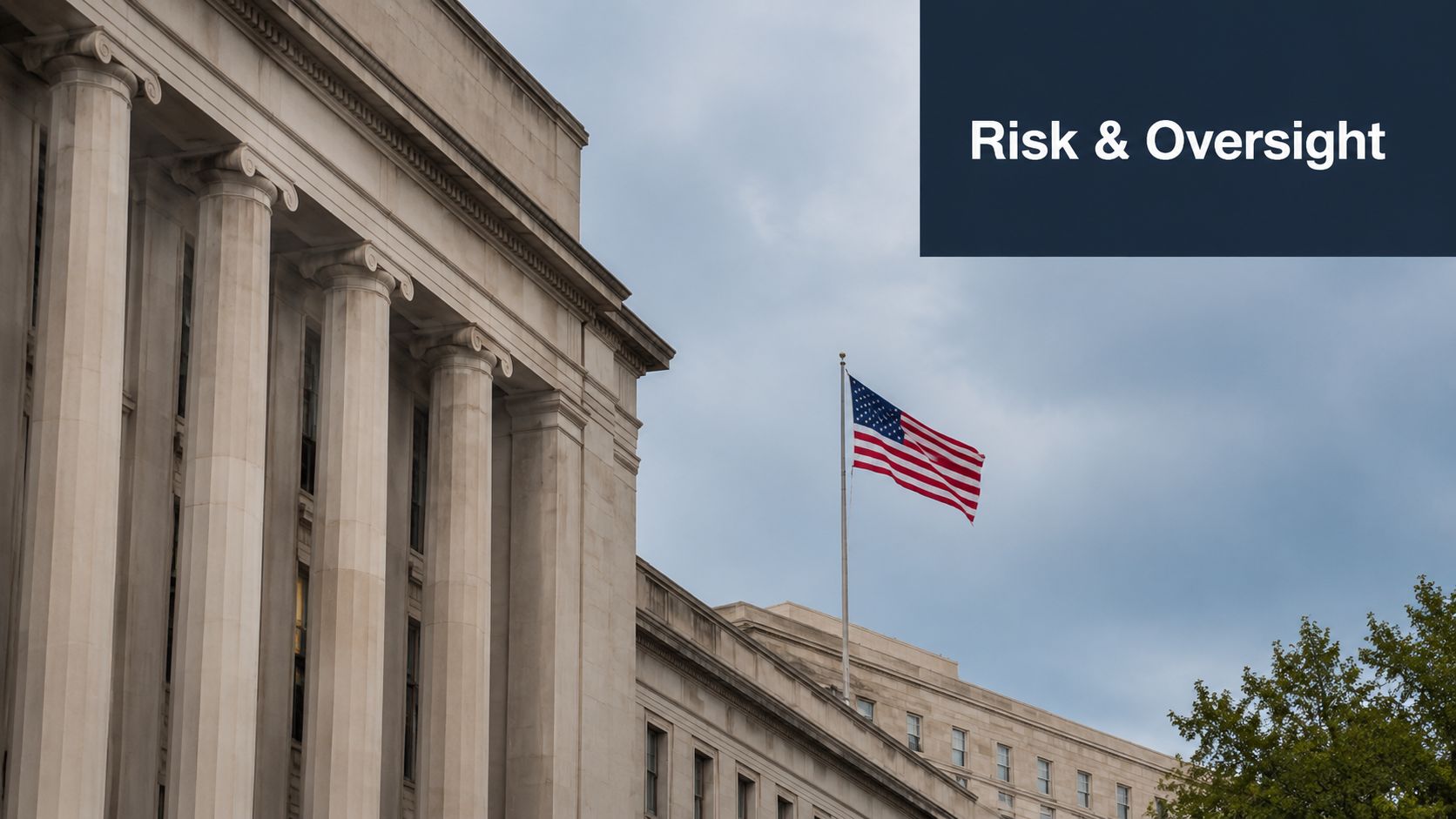 A grand neoclassical government building with tall pillars and the American flag flying against a cloudy sky.